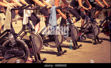Legs moving during a workout of spinning -----Imperia, IM, Italy - May 18, 2014: People perform a spinning session outdoors in an urban park of liguri Stock Photo