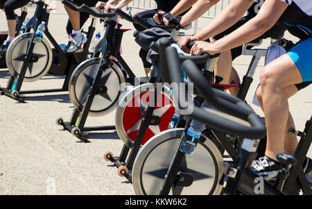 Legs moving during a workout of spinning-----Imperia, IM, Italy - May 18, 2014: People perform a spinning session outdoors in an urban park of liguria Stock Photo