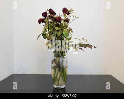 withered bunch of flowers in a glass vase Stock Photo