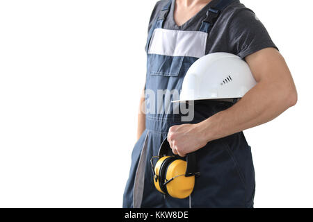 Worker holding white helmet and safety headphones isolated on white background. Protective wear theme. Stock Photo