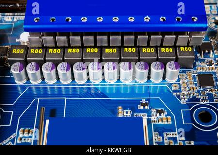 Computer circuit board with capacitors and heat sink. Stock Photo