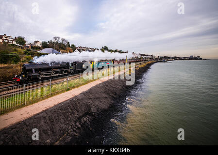 LMS Stanier Black Five 45212 with a vintage diesel class 47 named 'County of Essex' pulling Steam Dreams special train passing Chalkwell Beach on the Thames Estuary Stock Photo