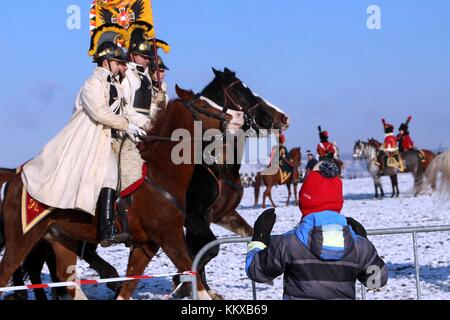 Tvarozna, Czech Republic. 2nd Dec, 2017. A boy watches mounted military reenactors portraying Austrian cavalry participating in the recreation of the Battle of Austerlitz. The reenactment, staged on the battle's 212th anniversary, occurred near the site of the original battlefield in Tvarozna, Czech Republic and involved approximately 1,000 participants from several nations. Credit: Toby Scott/Alamy Live News. Stock Photo