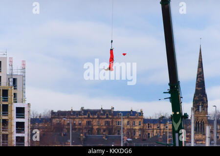 Glasgow, Scotland, UK. 2nd Dec, 2017. Santa enjoys a 160ft crane bungee jump in Glasgow. Credit: Skully/Alamy Live News Stock Photo
