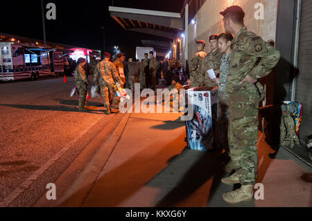 Fort Bragg, NC, USA. 1st Dec, 2017. Dec. 1, 2017 - FORT BRAGG, N.C., USA - Paratroopers line the street at Green Ramp on Pope Army Airfield, Friday, before the sun rises, waiting to donate their toys at the 20th Annual Randy Oler Memorial Operation Toy Drop. The airborne operation, hosted by the U.S. Army Civil Affairs & Psychological Operations Command (Airborne), is the world's largest combined airborne operation with paratroopers from nine allied nations participating. The annual event allows paratroopers the opportunity to help children in communities surrounding Fort Bragg Stock Photo