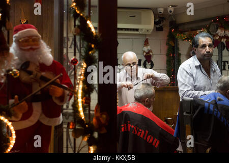 Bethlehem, West Bank. 2nd December, 2017. Barbershop in Bethlehem lights up with festive lights in anticipation of the large amount of tourist and pilgrims arriving for Christmas holidays. Credit: Gabi Berger/Alamy Live News Stock Photo