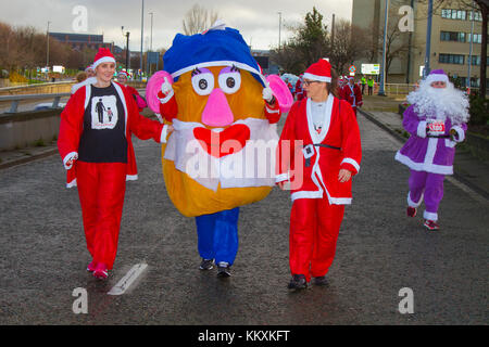 Liverpool, Merseyside, UK  3th December, 2017. The BTR Liverpool Santa Dash centre starts with a 5K road route beginning at the Pier Head on Canada Boulevard in front of the Liver Buildings. The festive spectacle with thousands of Santas mascots running for fun around the streets event is open to runners, joggers and walkers but everyone has to take part in the Santa suit provided either red for Liverpool FC  or blue for Everton FC.  It finishes in front of the Town Hall at Castle Street. Credit: MediaWorldImages /Alamy Live News Stock Photo