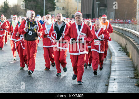 Liverpool, Merseyside, UK. 3rd December. 2017.  The 14th Liverpool Santa Dash back in the city centre. Once again thousands of Scouse Santas turned Liverpool City Centre into a sea of red (with a splash of Everton blue) as they filled the streets with a mix of excitement and festive fun.  Now generally acknowledged as the curtain raiser for Christmas, the Liverpool Santa Dash attracts runners, joggers, uni-cyclists, stilt walkers, business groups and whole families as they make their way around a 5K course around the city.  Credit: Cernan Elias/Alamy Live News Stock Photo