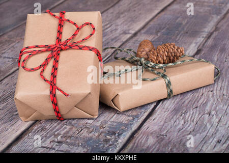 Two brown gift boxes tied with string on a wood textured surface Stock Photo