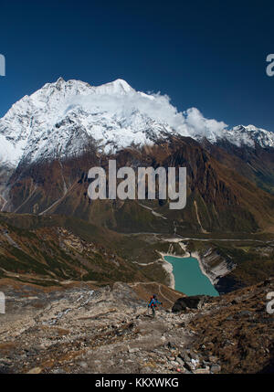 Looking out at Birendra Tal and Kutang Himal on the Tibetan border from the Manaslu Basecamp trail, Nepal Stock Photo