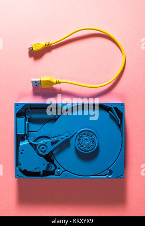 Blue colour hard disc and yellow USB cable Stock Photo