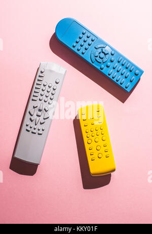 Many Colored TV remote controls on bright backgrounds. Stock Photo
