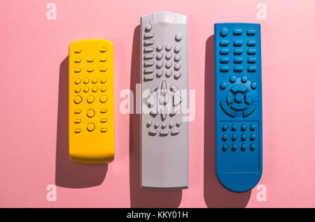 Many Colored TV remote controls on bright backgrounds. Stock Photo