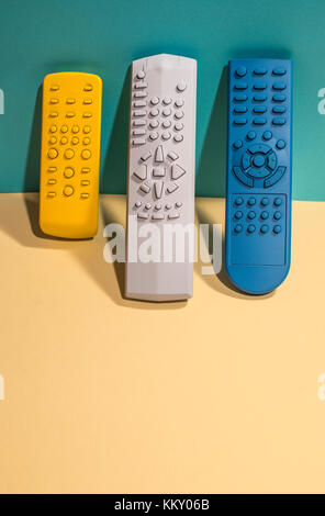 Many Colored TV remote controls on bright backgrounds. Stock Photo