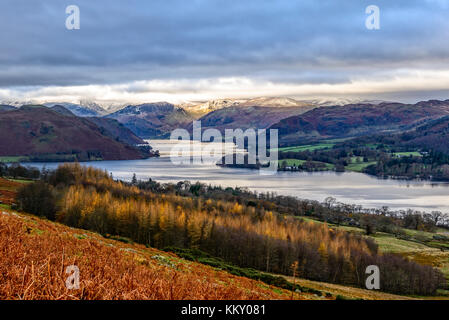 Late autumn view across Ullswater with snow covered fells in the distance taken from the Pooley Bridge to Howtown path Stock Photo