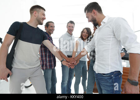 .friendly team of designers clasped their hands together Stock Photo