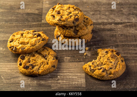 chocolate chip cookies on a wood table dark table Stock Photo