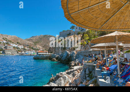 Seafront bar and bathing area just outside Hydra Town, Hydra, Greece Stock Photo