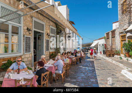 Traditional Greek taverna on a typical street near the harbour, Hydra town, Hydra, Saronic Islands, Greece Stock Photo