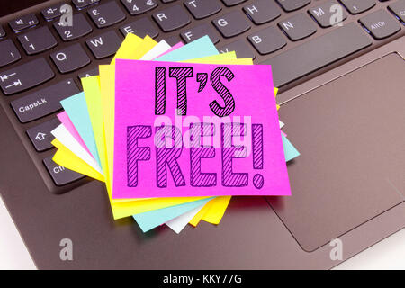 Writing It's Here text made in the office close-up on laptop computer keyboard. Business concept for Free Things Workshop on the black background with Stock Photo