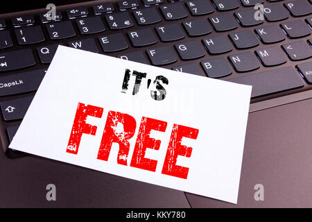 Writing It's Here text made in the office close-up on laptop computer keyboard. Business concept for Free Things Workshop on the black background with Stock Photo