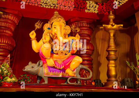 An idol of Lord Ganesha, sitting on his vehicle - a mouse, also known as Ganapati or Vinayaka, his image is found throughout India Stock Photo