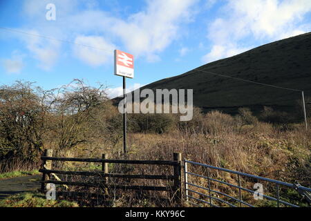 The sign of Sugar Loaf railway station, the most remote station on the Heart of Wales Line, situated by the A483 road, Powys, Wales, UK. Friday 01 Dec Stock Photo