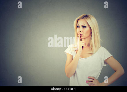 Beautiful woman with a thoughtful face expression looking up Stock Photo