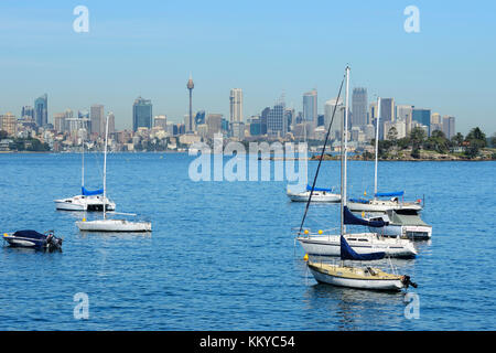 Yachts at anchor in Hermit Bay, Vaucluse, with Sydney Central Business District in background - Sydney, New South Wales, Australia Stock Photo