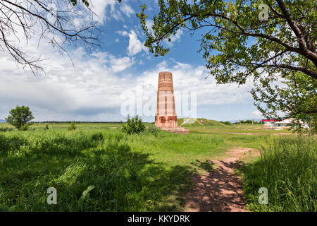 Burana tower, tall and large minaret in the ruins of the ancient site of Balasagun, in Kyrgyzstan. Stock Photo