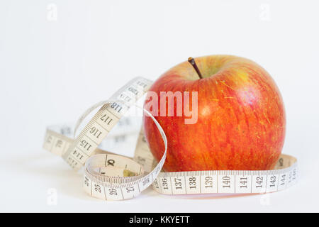 Red apple with measuring tape isolated on white Stock Photo