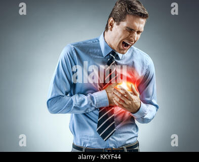 Office manager holding hands on painful chest. Medical concept. Heart attack. Stock Photo