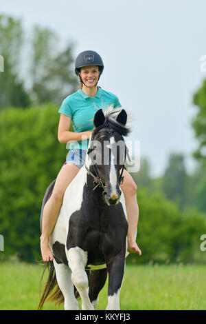 A barefoot woman riding a horse on a beach Stock Photo - Alamy