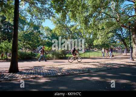 NEW YORK CITY - SEPTEMBER 24, 2016: People walking and cycling in Tompkins Square Park in East Village on a warm October day Stock Photo