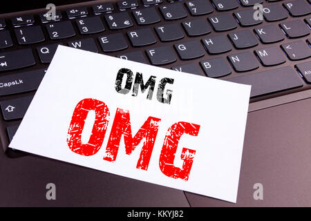 Writing OMG Oh My God text made in the office close-up on laptop computer keyboard. Business concept for Surprise Humor Workshop on the black backgrou Stock Photo