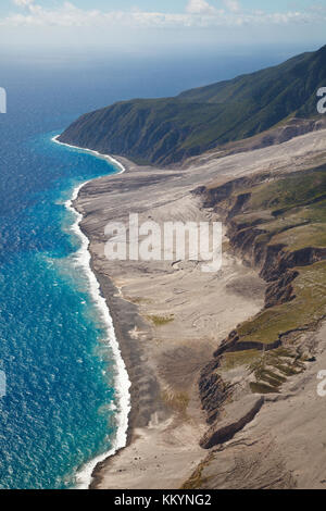 The remains of recent pyroclastic flows of the Soufriere Hills Volcano form the east coast of Montserrat. Aerial view from helicopter. You can see fre Stock Photo