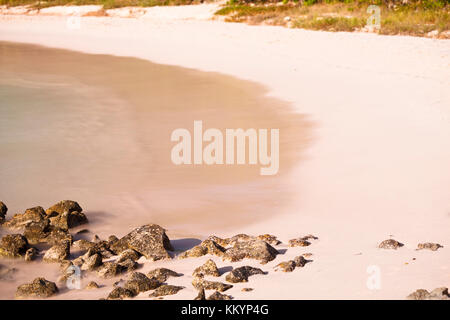 Daytime long exposure of the beautiful Half Moon Bay in Antigua. Stock Photo