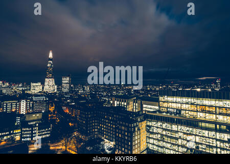 Aerial view of the modern illuminated office building in the city ...