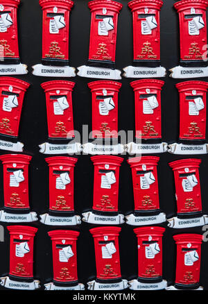 Many fridge magnets in shape of red  post boxes  for sale in tourist gift shop in Old Town of Edinburgh, Scotland, United Kingdom Stock Photo