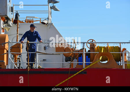 A Coast Guard member stands on the deck of the cutter Mackinaw during the annual 2017 Christmas Tree Ship reenactment at Navy Pier in Chicago Stock Photo