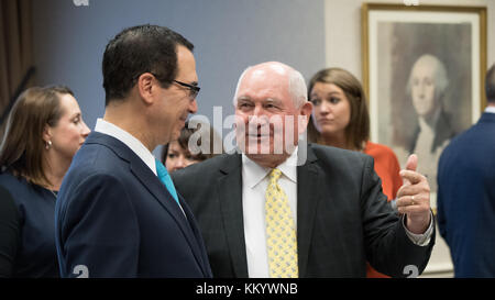 U.S. Treasury Secretary Steven Mnuchin (left) talks to U.S. Agriculture Secretary Sonny Perdue at the U.S. Department of Agriculture Headquarters September 28, 2017 in Washington, DC.  (photo by Lance Cheung via Planetpix) Stock Photo