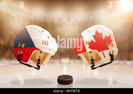 Low angle view of hockey helmets with Czech Republic and Canada flags painted and hockey puck on ice in brightly lit stadium background. Concept of in Stock Photo
