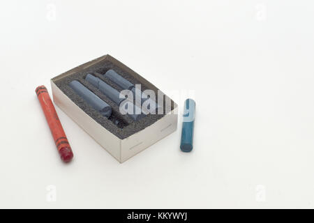 pastel crayon on sponge in box and old colored wax chalks around Stock Photo