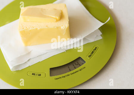 Stick of butter on digital scale in preparation for baking Stock Photo