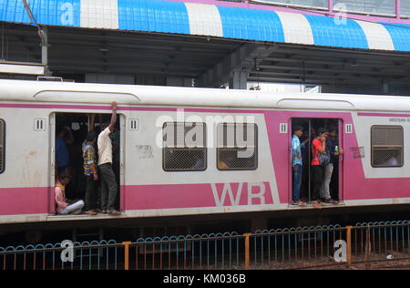 People travel at Dadar train station in Mumbai India. Stock Photo