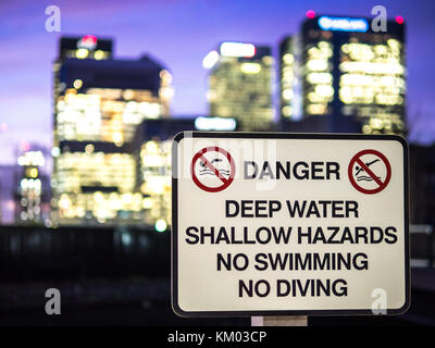Danger Sign in front of London Banks at the dockside Canary Wharf Stock Photo