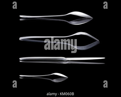 Stainless modern cutlery set with reflections side views. Spoon, fork, knife and teaspoon isolated on black, clipping path included Stock Photo