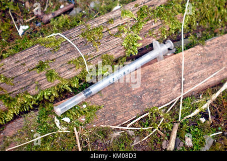 Discarded syringe signs of illegal drug use Stock Photo