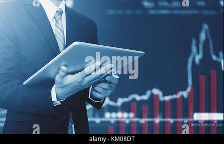 Businessman using digital tablet, raising graph background. Business growth, investment and invest in stock exchange market Stock Photo