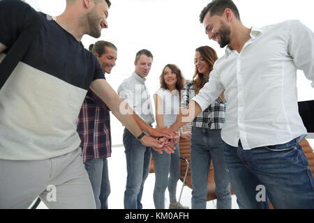 .friendly team of designers clasped their hands together Stock Photo